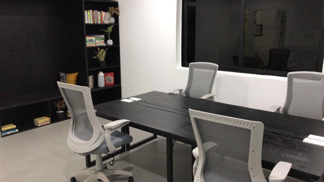 5AAP — the same meeting room from the head of the table, the shelved bench and display niche at left