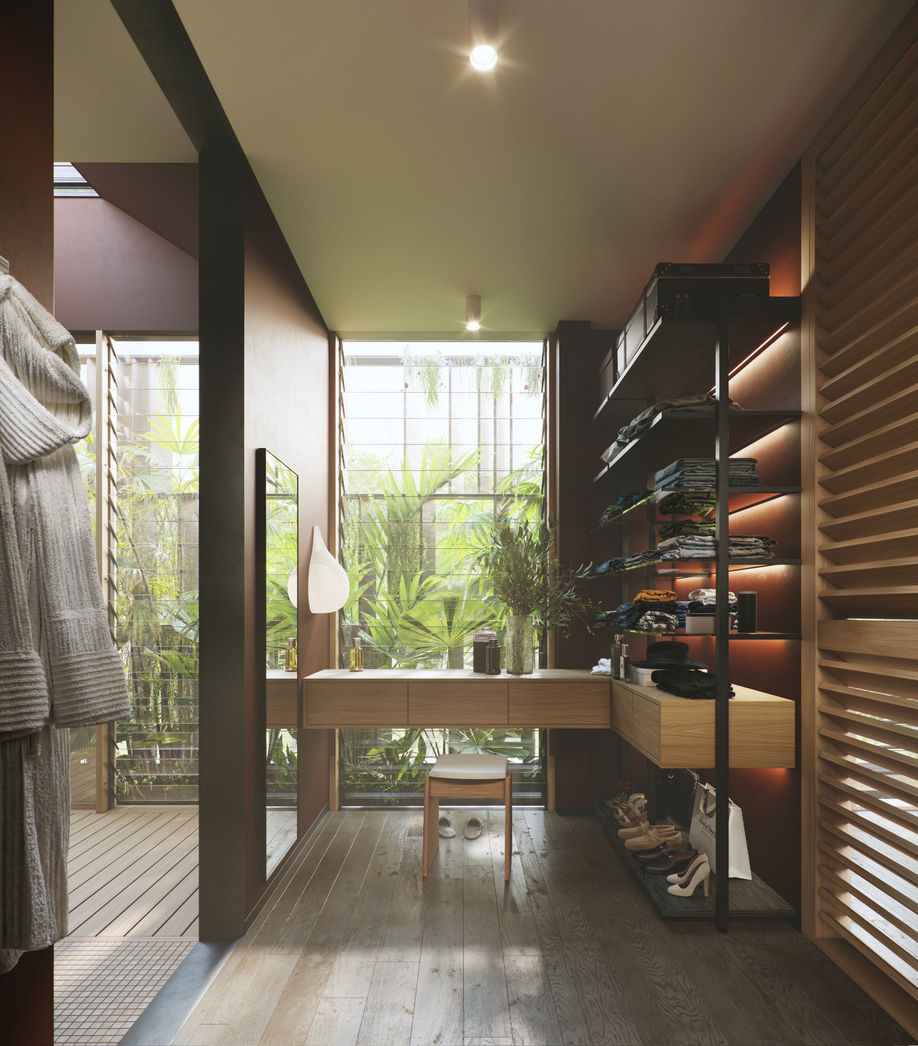 A-A dressing room: a floating timber vanity and stool before a tall planted light-well with horizontal glazing bars, a full-length mirror and black open shelving of folded clothes on lit shelves with shoes and bags below, a timber louvre wall at the right and a robe hanging at the left.
