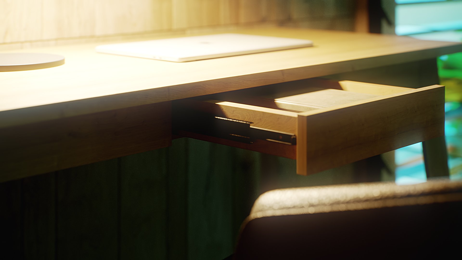 Ackon Desk drawer close-up: open timber drawer on black metal slides with a book inside, laptop above, golden light at the left against a green backdrop