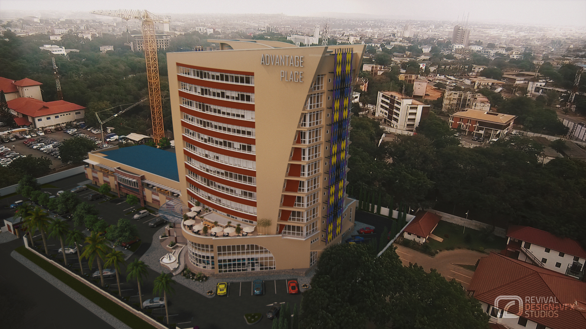 Advantage Place tower from above: a beige curved facade banded in red with silver ADVANTAGE PLACE lettering near the top, diamond cladding in purple, yellow and blue on the right wall, rooftop umbrellas and palm-lined parking below a hazy skyline.