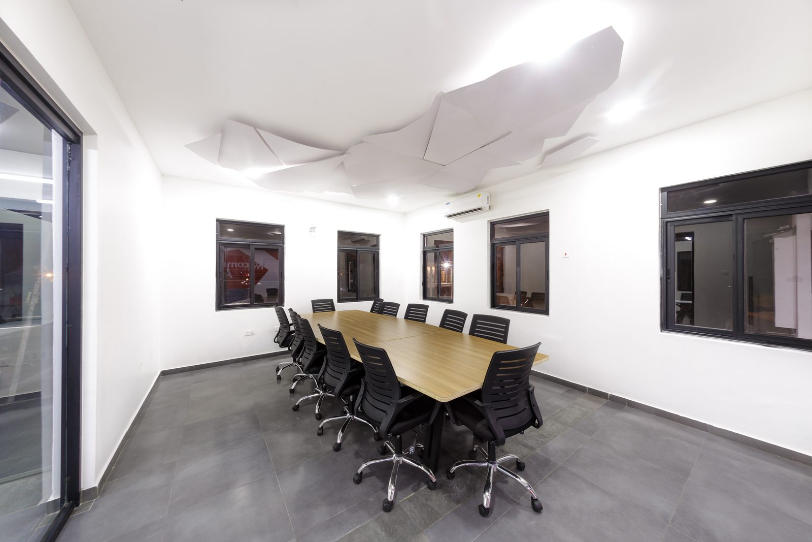 AFG - The boardroom from the door end, the faceted ceiling installation running the length of the room over the table.