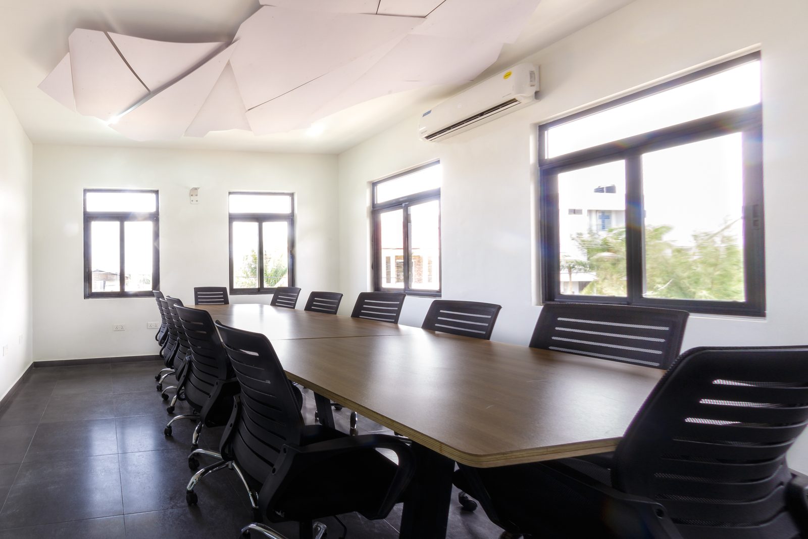AFG - The same end of the table from slightly further back, chairs either side and the faceted ceiling above.