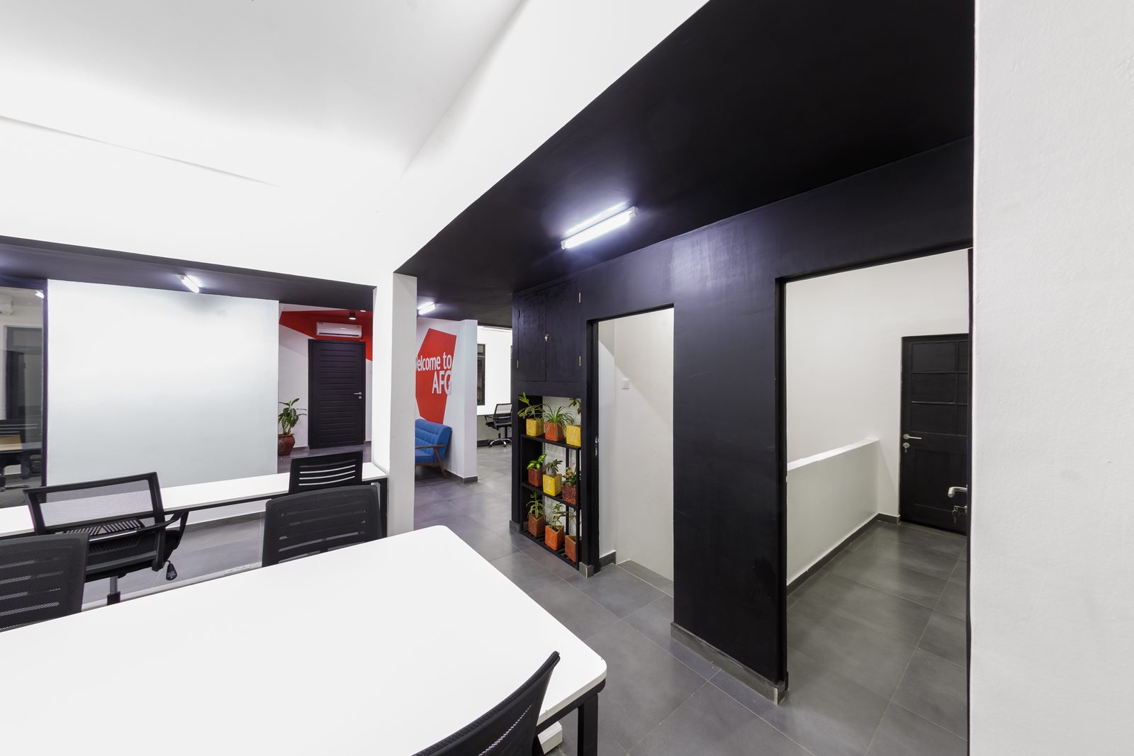 AFG - The junction between workspace and circulation, black joinery and a glazed screen on the left.