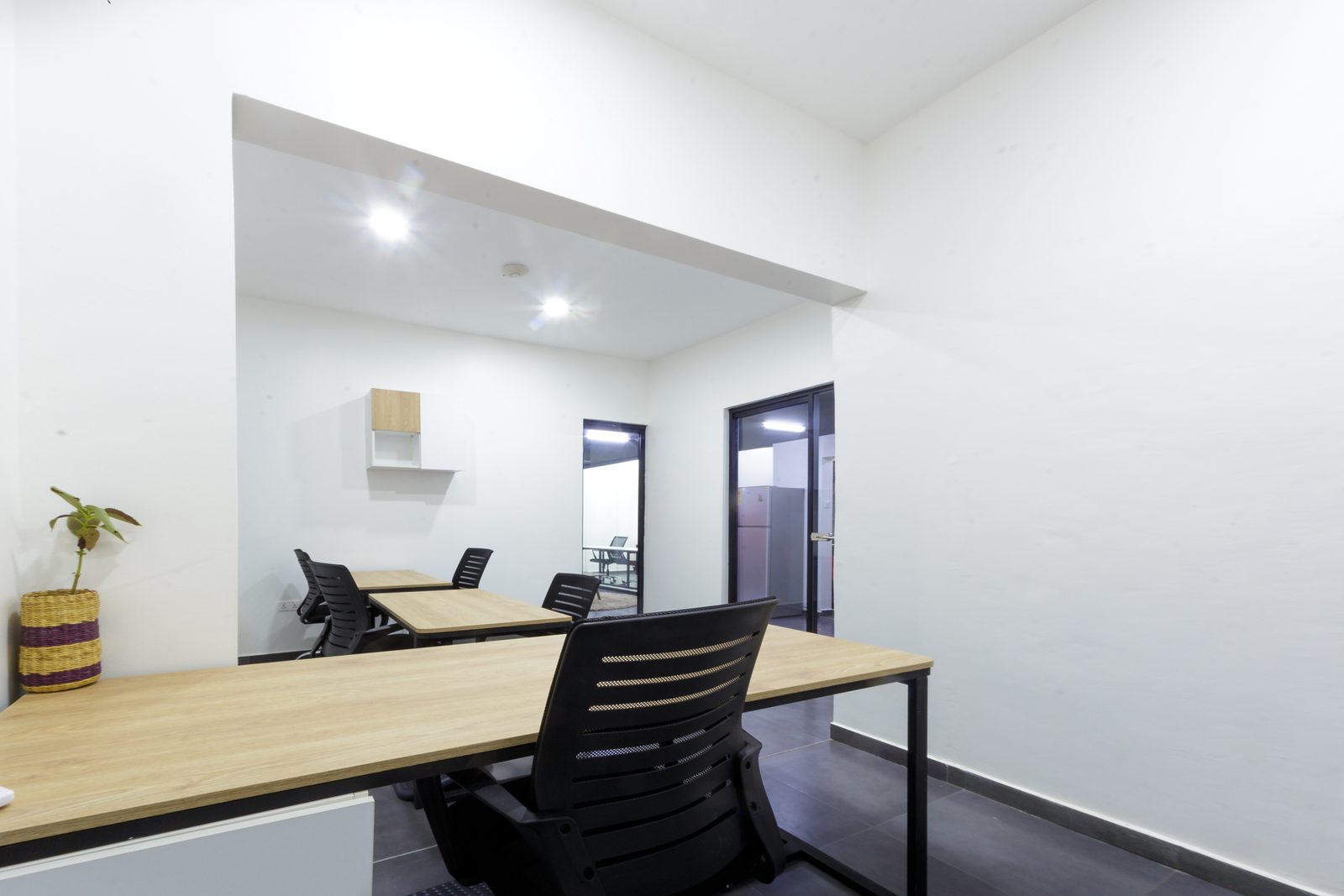 AFG - The management office from its short end, ceiling bulkhead and downlights over the plywood desks.