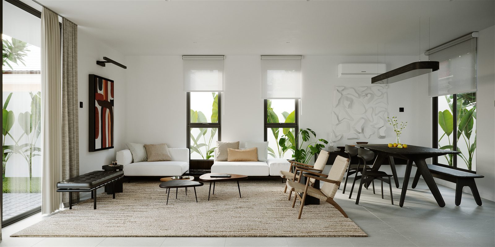 Living and dining as one volume: a white sofa and low tables on the rug at left, a black trestle dining table with a bench and woven chairs at right, sculptural white wall relief between the windows.