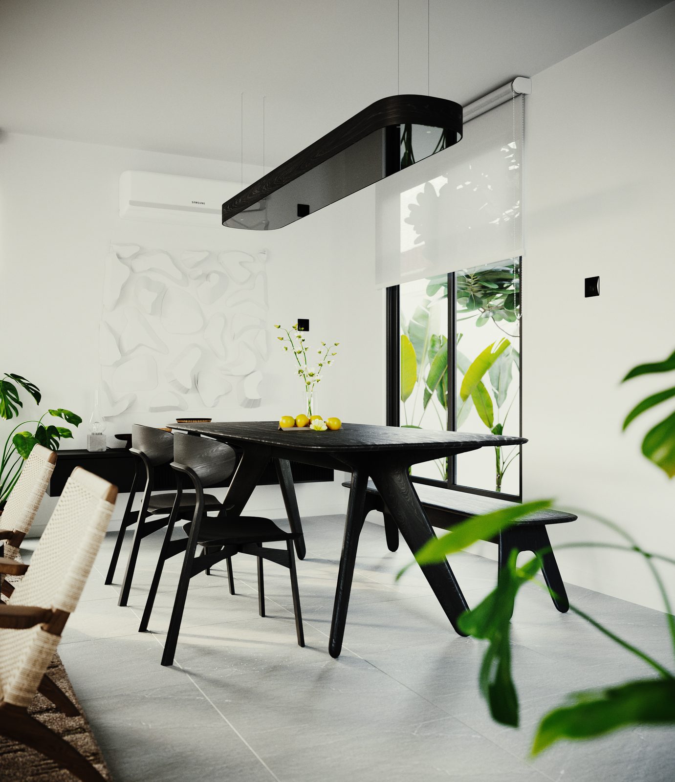 Portrait view of the dining table in black with its matching bench and chairs, a long black linear pendant above, and the white carved relief panel on the wall behind.