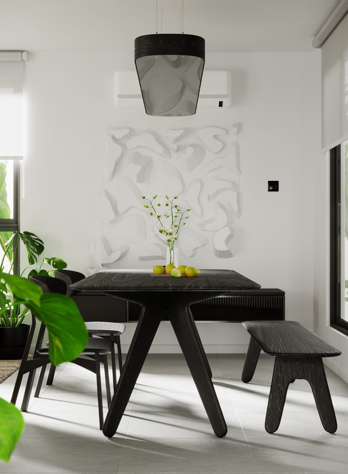 The dining table head-on under a paper lantern pendant, the carved relief lit behind it and planting at either side.