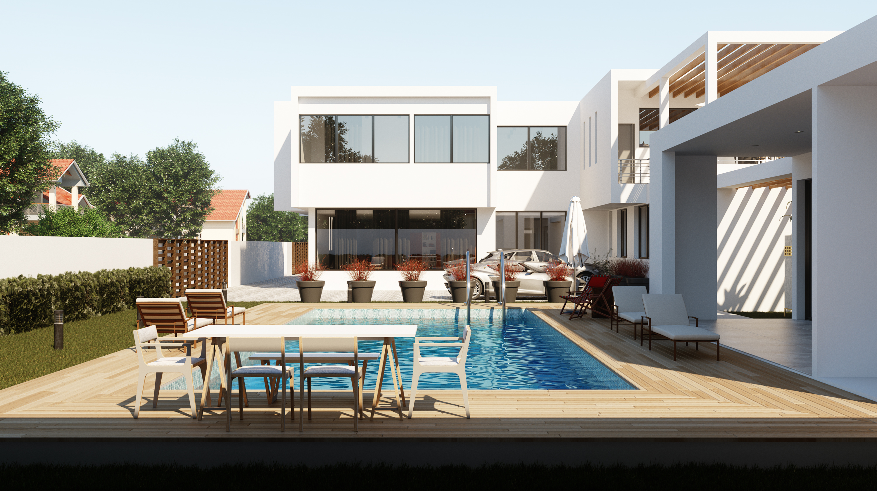 Rectangular pool set in a timber deck with dining table and loungers, white two-storey house beyond in daylight