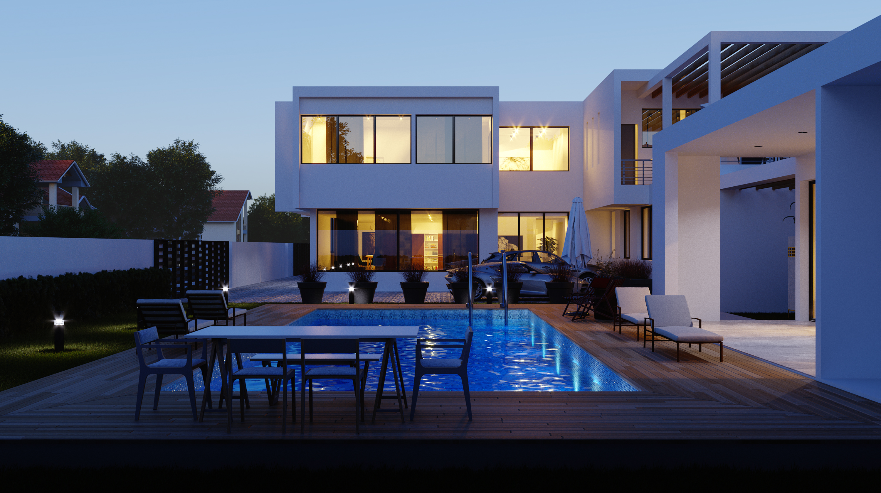 The same pool terrace at dusk, interior lights warm and the pool lit from below