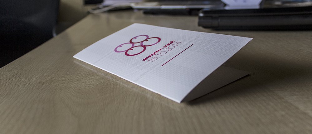 The card standing folded on a desk, showing how the single fold holds its own shape