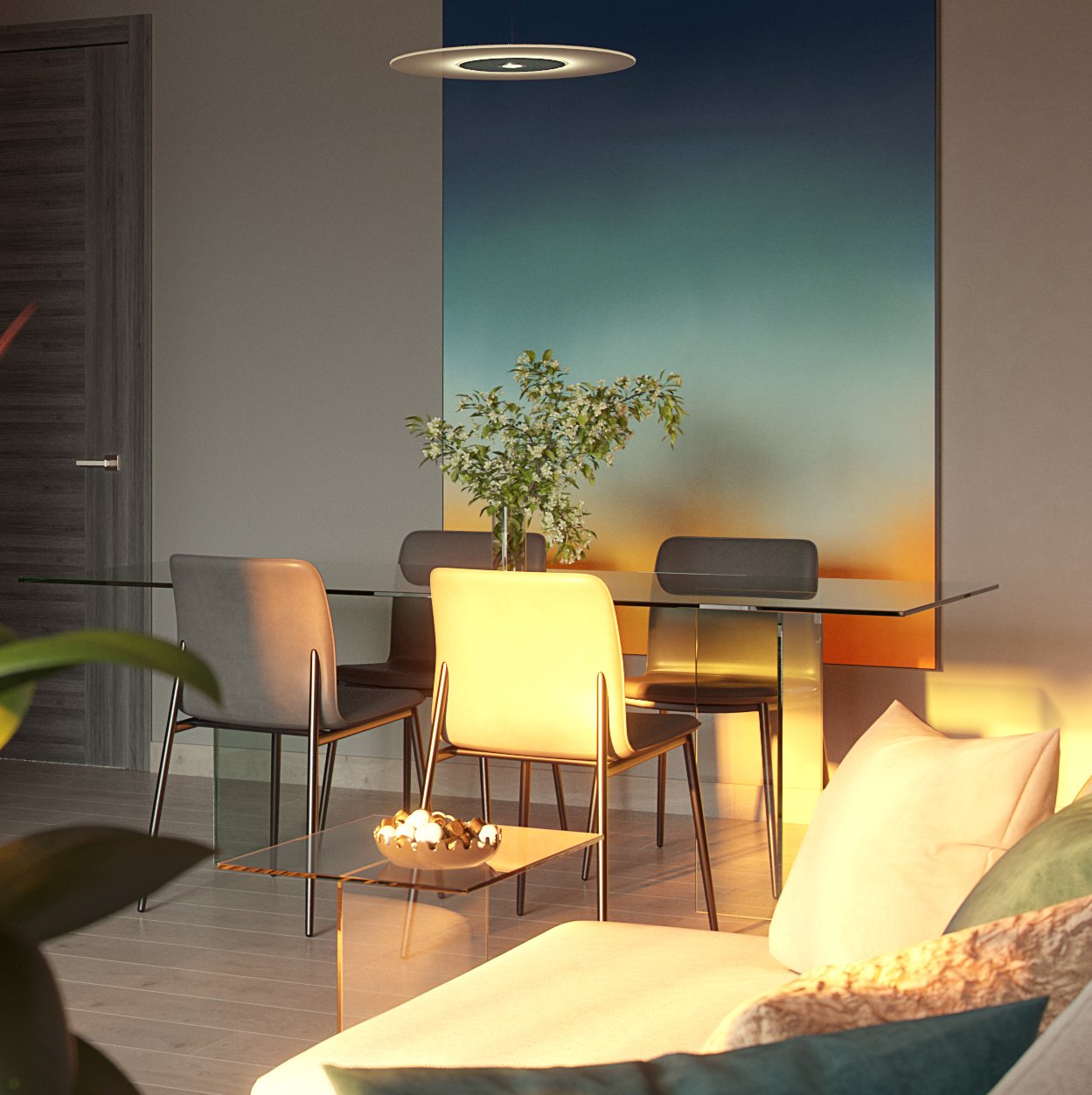 Avalon - the dining corner at dusk: a glass-topped table with mixed grey and cream chairs before a blue-to-orange gradient wall panel, blossom in a vase on the table, a disc pendant above and a glass side table with a bowl in the foreground