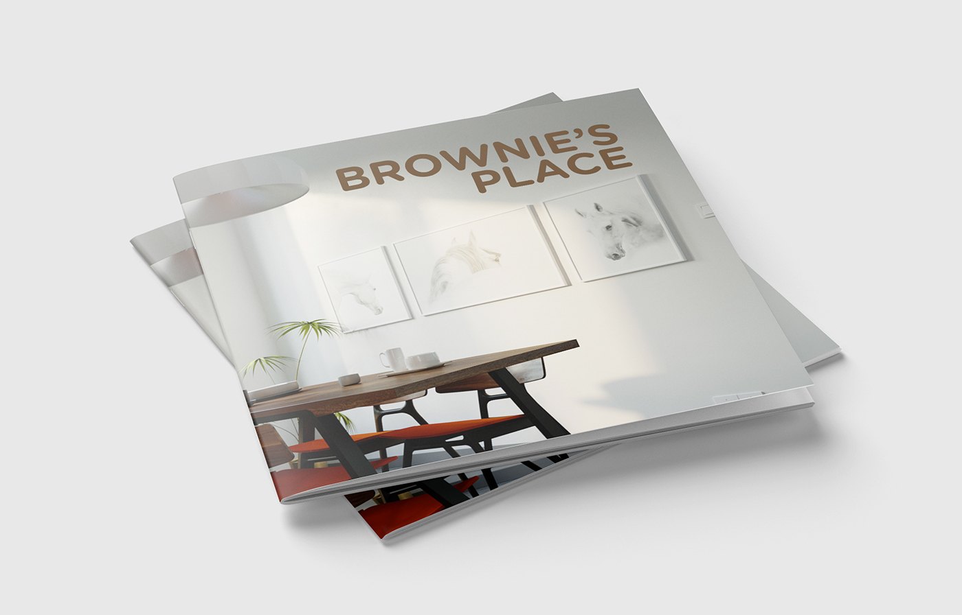 Brochure mockup: two copies of the booklet stacked at an offset on a pale grey ground, so the dining room cover image and the brown BROWNIE&rsquo;S PLACE title read twice, with soft shadows under the corner of the lower copy.