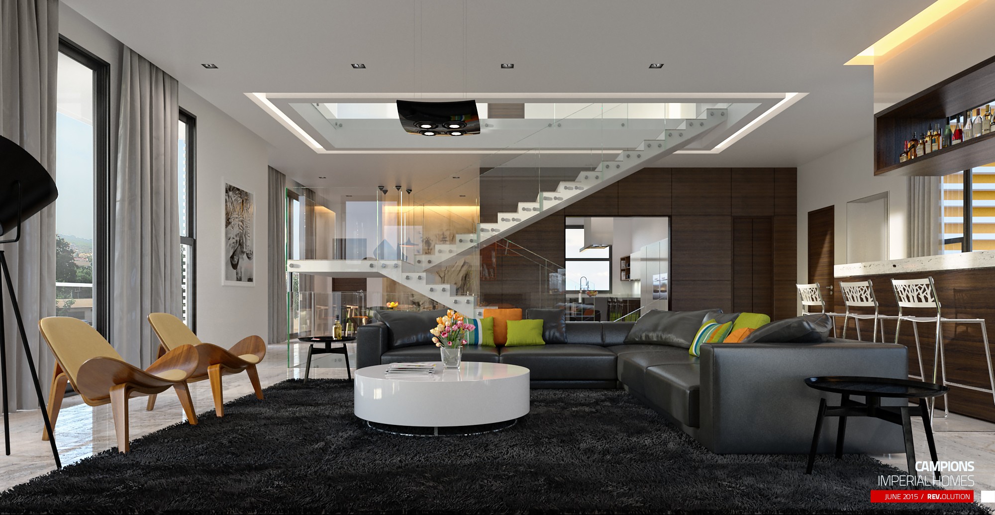 The double-height living room: a floating stair against a glazed slot, grey sofas with lime cushions around a white round coffee table, and a kitchen bar with stools behind