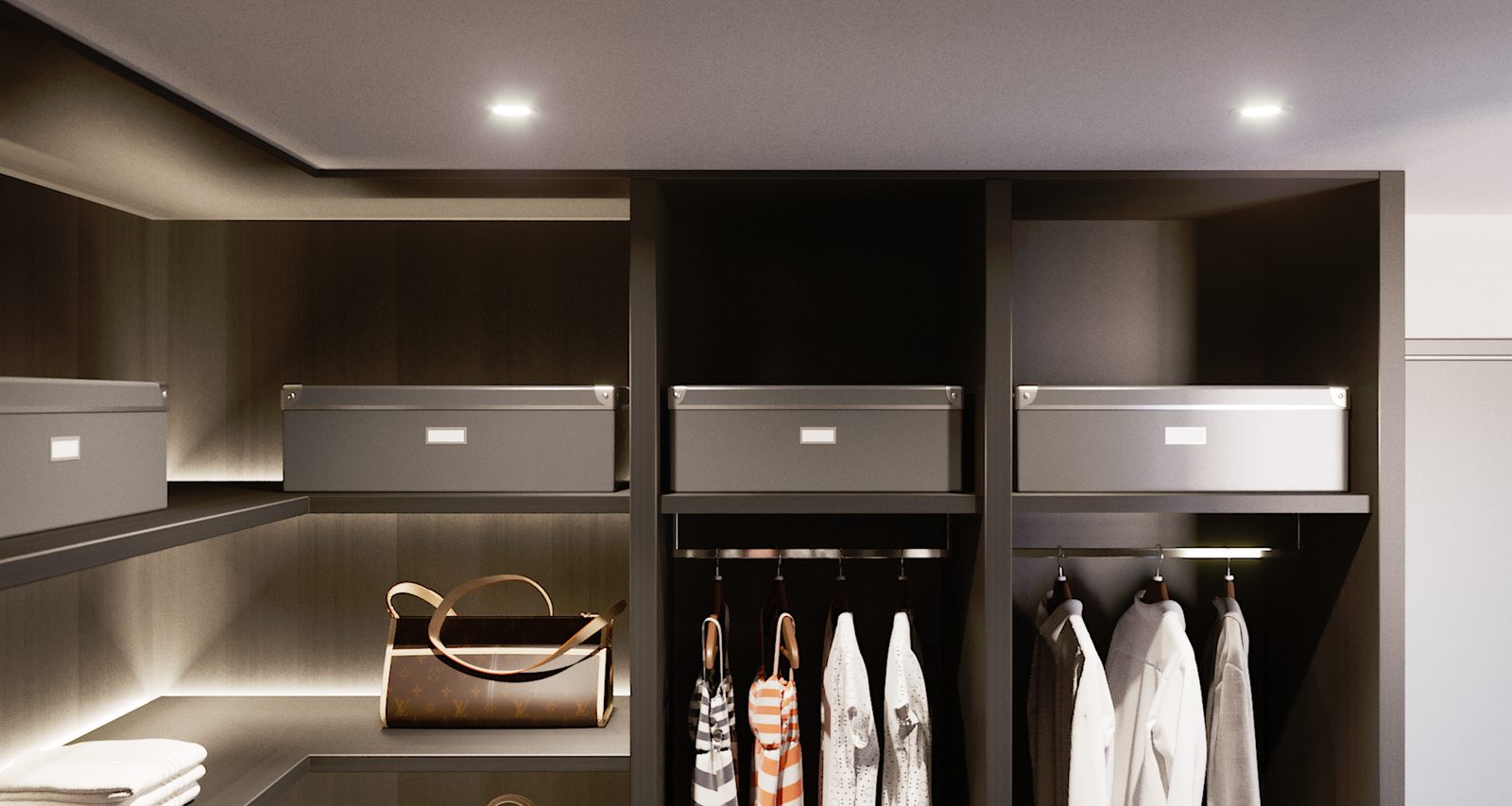 Tower Cascades - Wardrobe bay: grey storage boxes on an upper shelf over hanging garments and a lit rail.