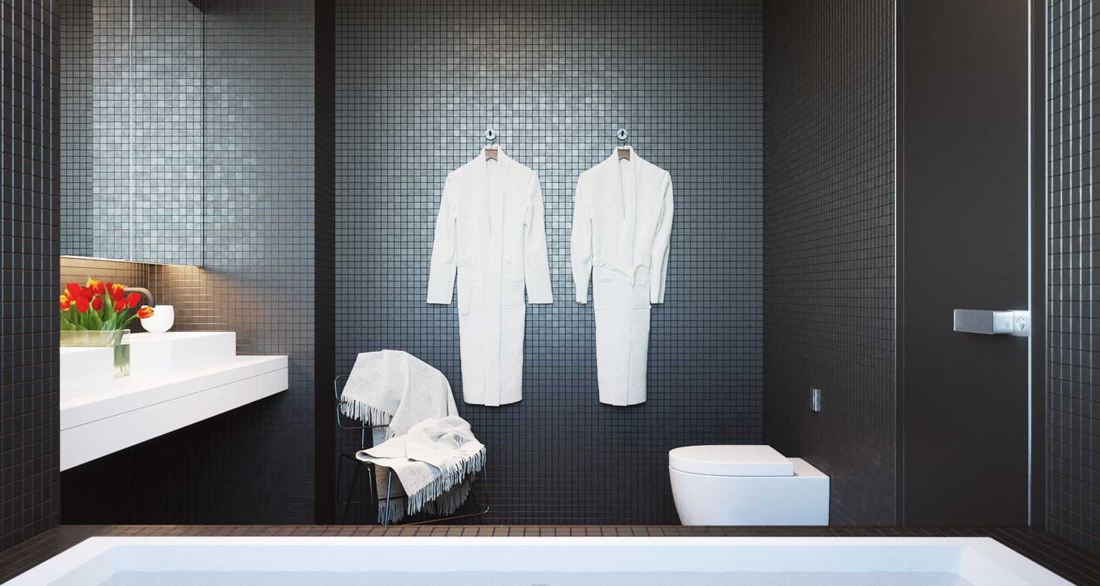 Tower Cascades - Bathroom: two white robes hanging on the dark mosaic wall above the edge of the tub, the vanity with red flowers to the left and a wall-hung WC to the right.