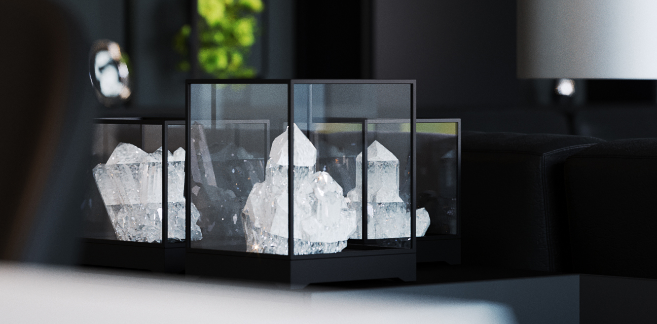 Details — the same cases brought closer: three crystals catching the light inside their glass, the edge of a dark sofa behind and a lampshade just out of frame