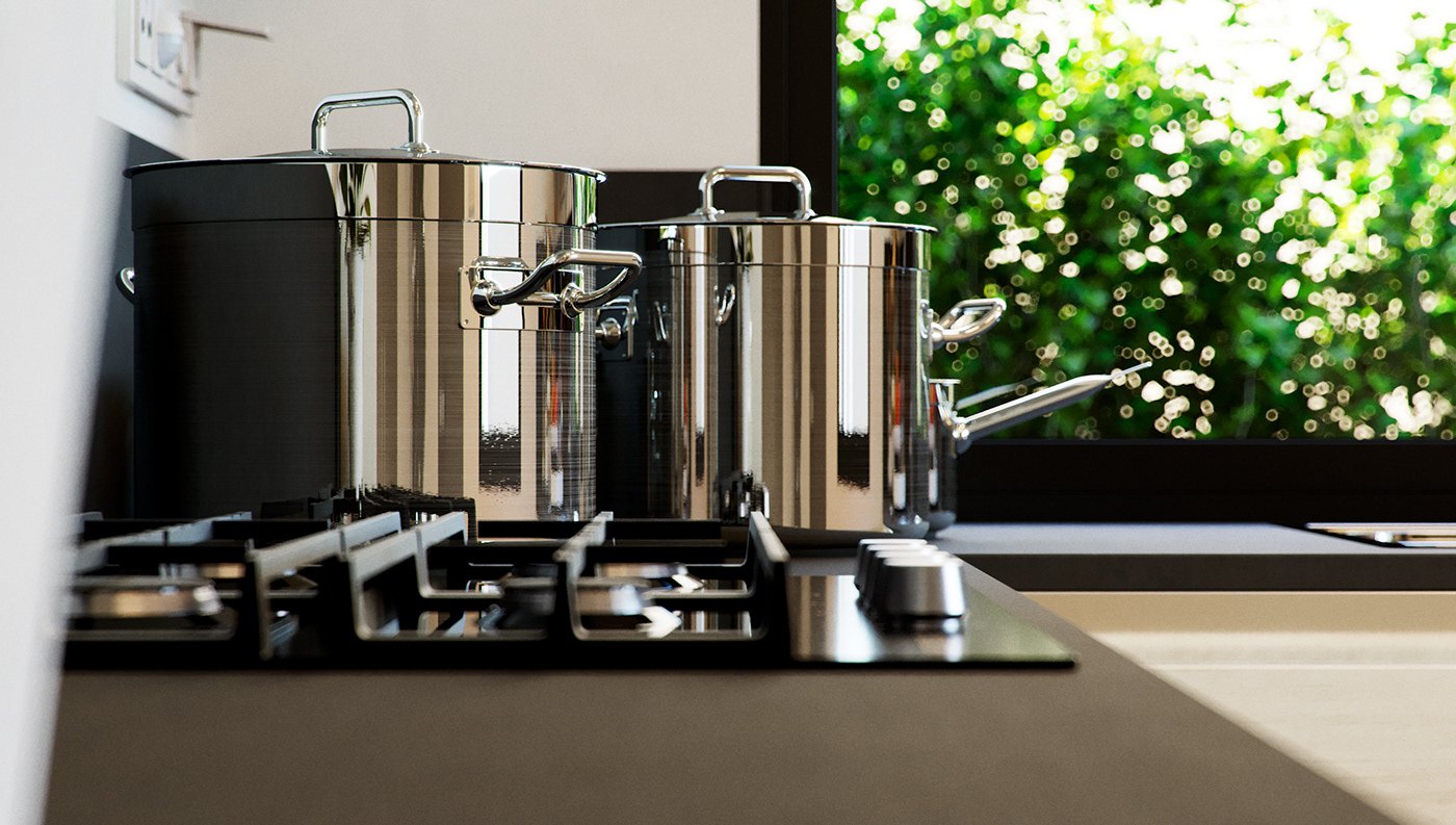 Detail render across a black kitchen counter: stainless steel pots and a gas hob in shallow focus, with a bright green clipped hedge filling the window behind and daylight raking across the worktop.