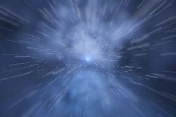 Warp frame: white and pale blue streaks radiating from a small bright core at the centre of a dark blue field, the burst at its fastest and most abstract point before any shape resolves.