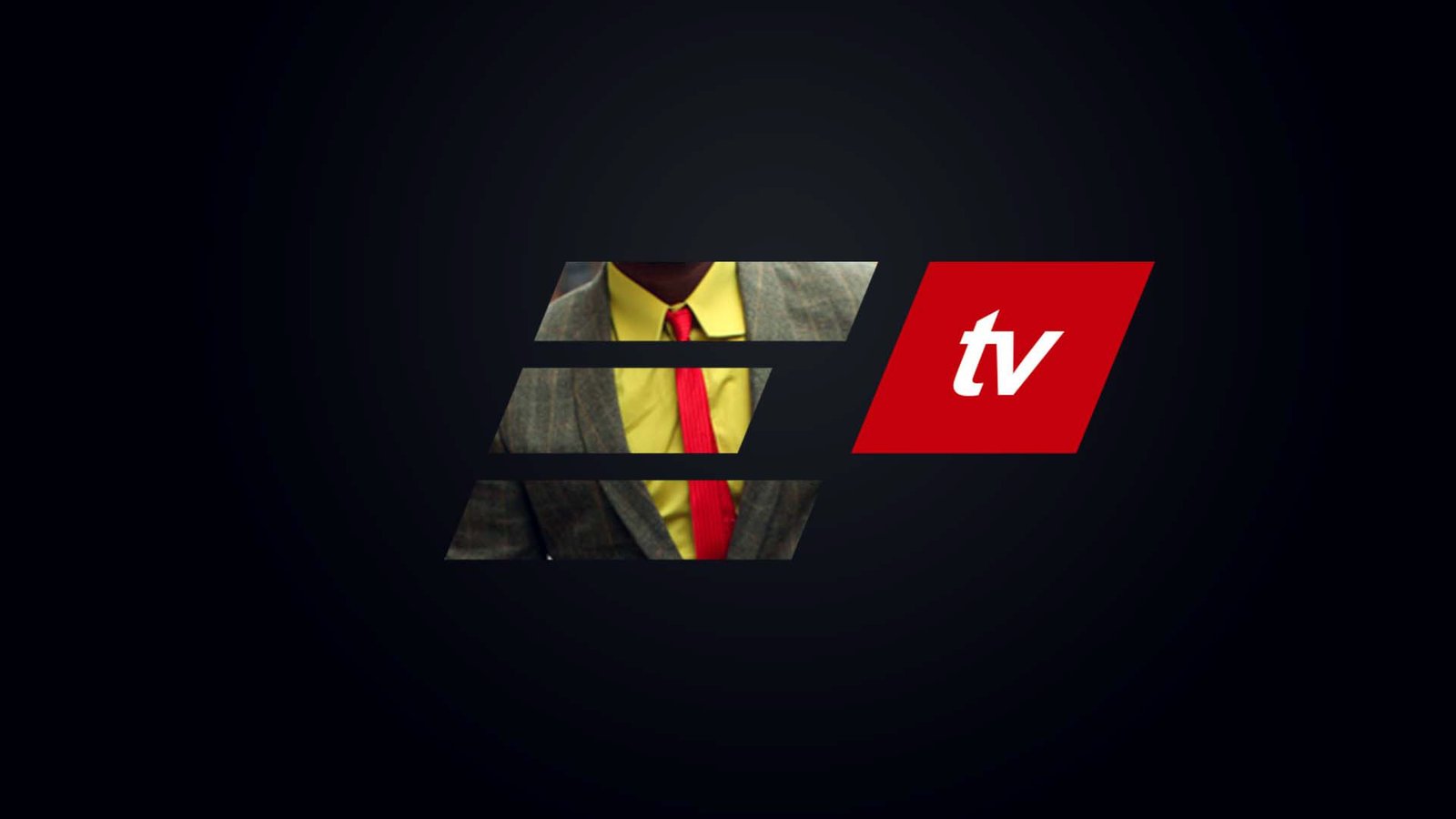 ELO TV ident mid-animation: the masked suit composition again with the red tv parallelogram enlarged to roughly double its size against the tweed, yellow shirt and red tie.
