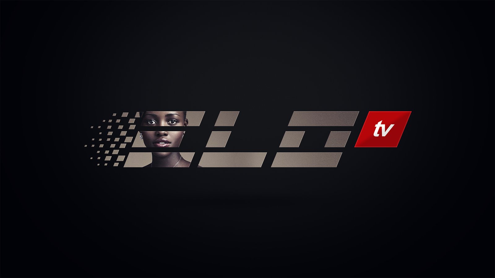 ELO TV ident frame: a smiling bearded man wearing strung yellow and white beads, his portrait masked inside warm cream letterforms on black with the red tv block at right.