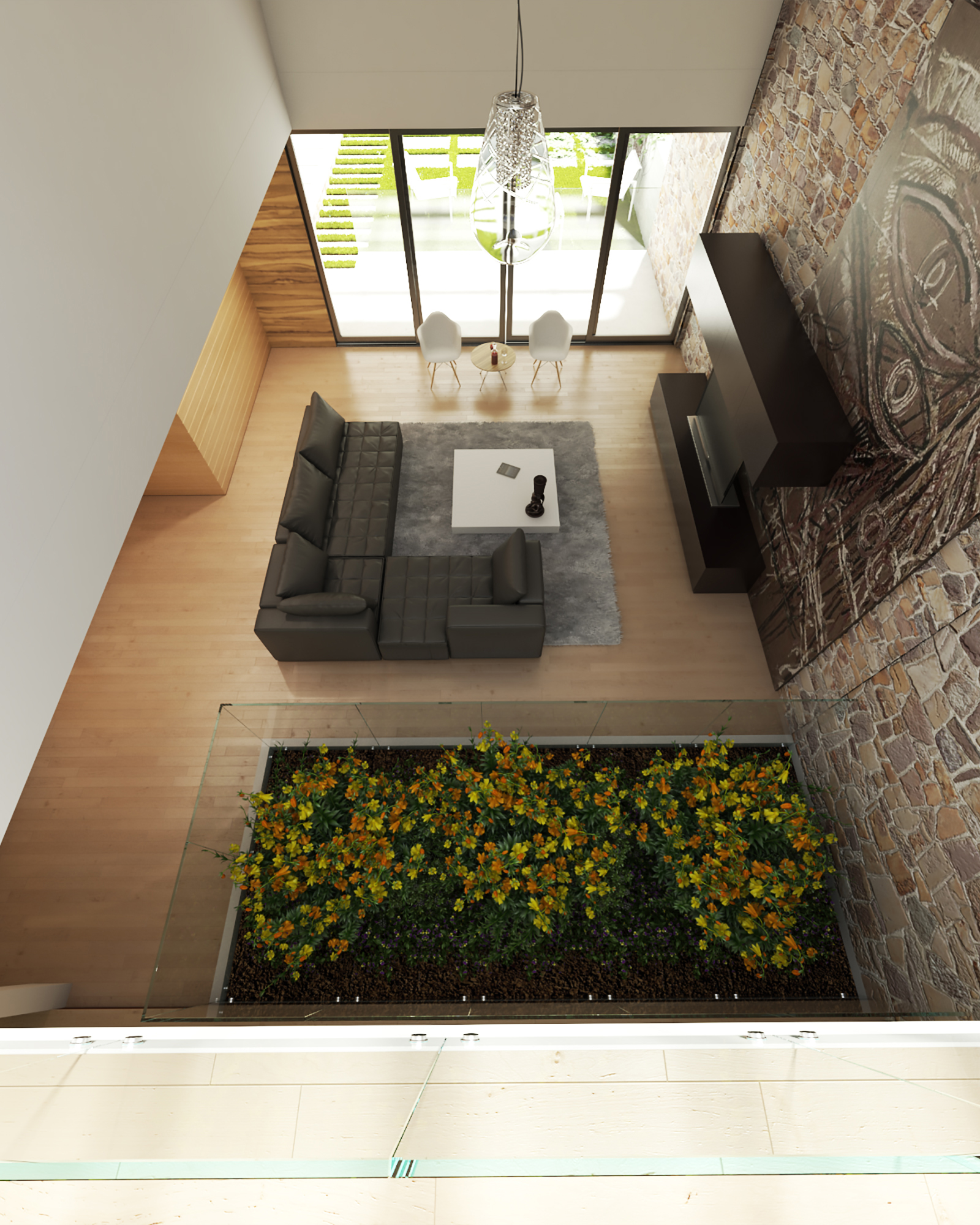 Fule - top-down view of the double-height living room: charcoal L-shaped sofa on a grey rug, white chairs by the garden doors, timber slat wall, stone-clad wall with a dark artwork and a glazed balustrade over a planter of yellow and orange flowers
