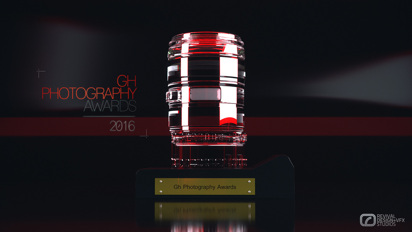 The lens-barrel award at its brightest, red light flooding the glass above the brass Gh Photography Awards nameplate, a red band crossing the frame behind the title and the piece reflected in the table beneath it