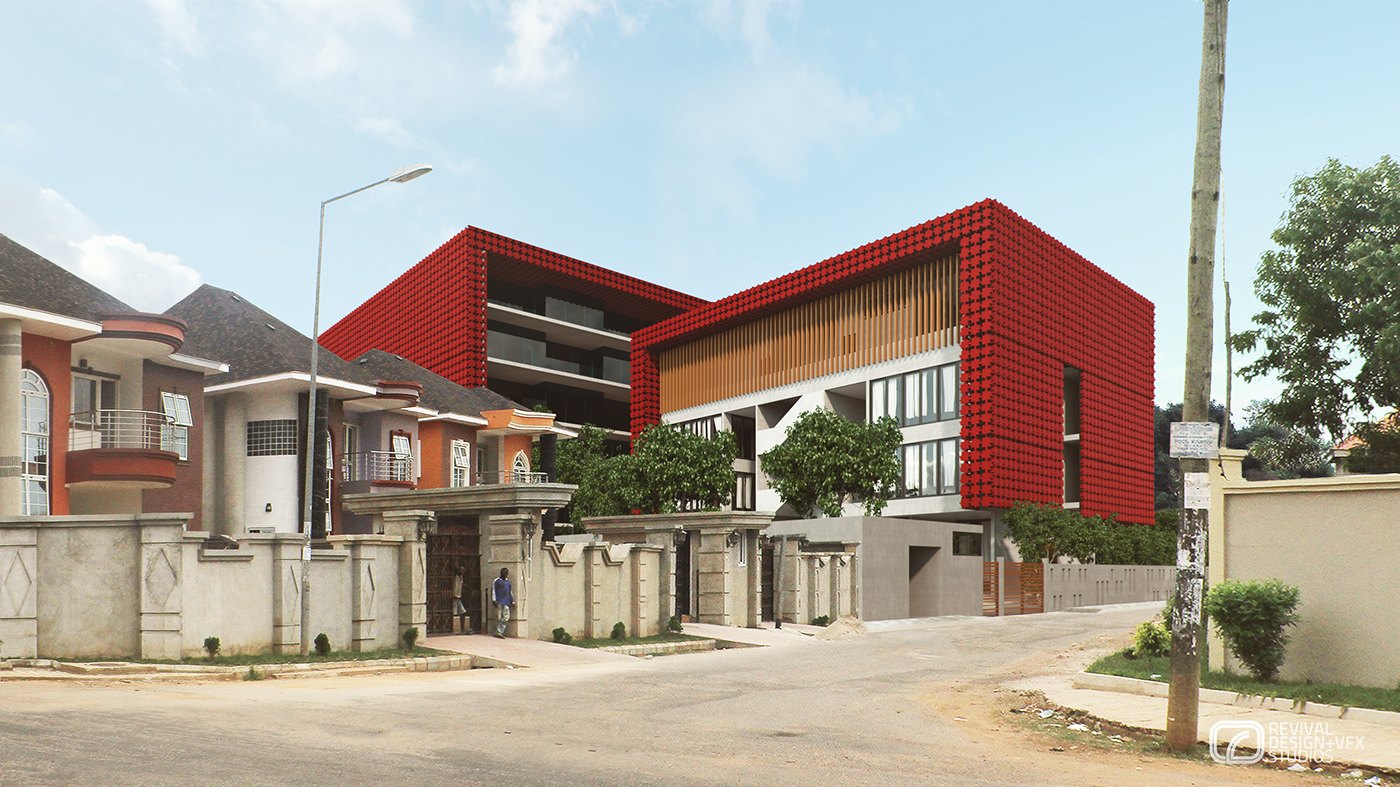Street-level exterior render: the red building with a timber-slat panel on its flank sits among low residential houses behind a concrete boundary wall, a road and utility pole in front, under a pale daytime sky.