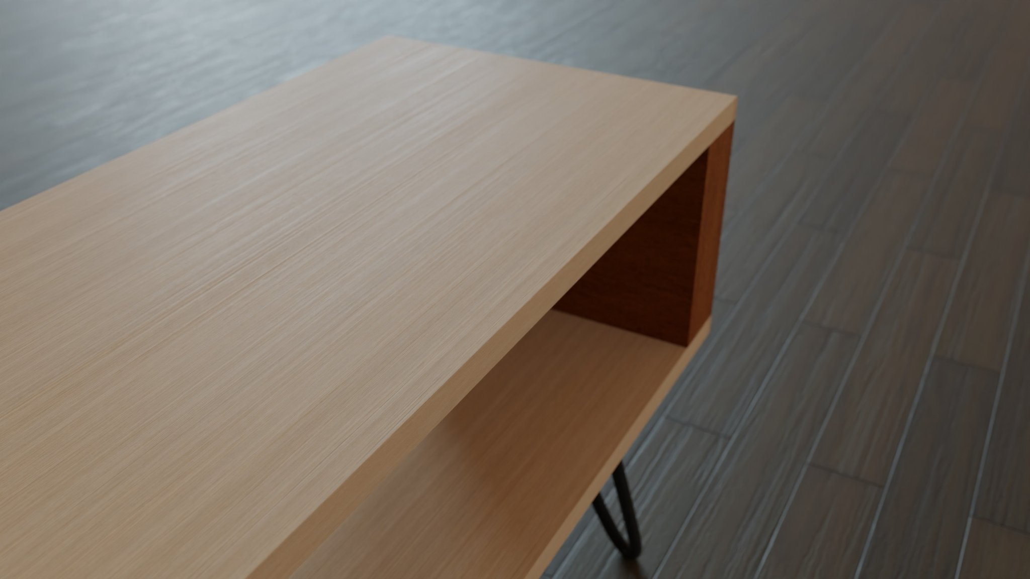 Lamu console from above: an oak top and lower shelf returning into a walnut end panel, a black tubular leg just visible, standing on grey plank flooring.