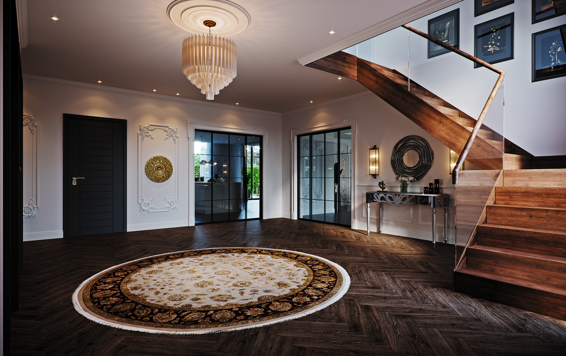 Link Drive Rd. entrance hall: a floating walnut stair with a glass balustrade and copper handrail rising at right, a tiered white chandelier dropped from a circular ceiling rose, a round cream-and-black medallion rug on dark herringbone boards, mirrored console beneath a coiled round mirror, gilt relief medallion and framed botanical prints on the panelled walls.