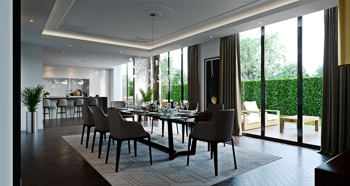 Link Drive Rd. dining room from the head of the table: the same grey chairs and dark set table before a wall of tall windows onto a clipped hedge and a deck with wooden loungers, the kitchen and its bar stools open to the left, a potted palm in a chrome urn by the glass.