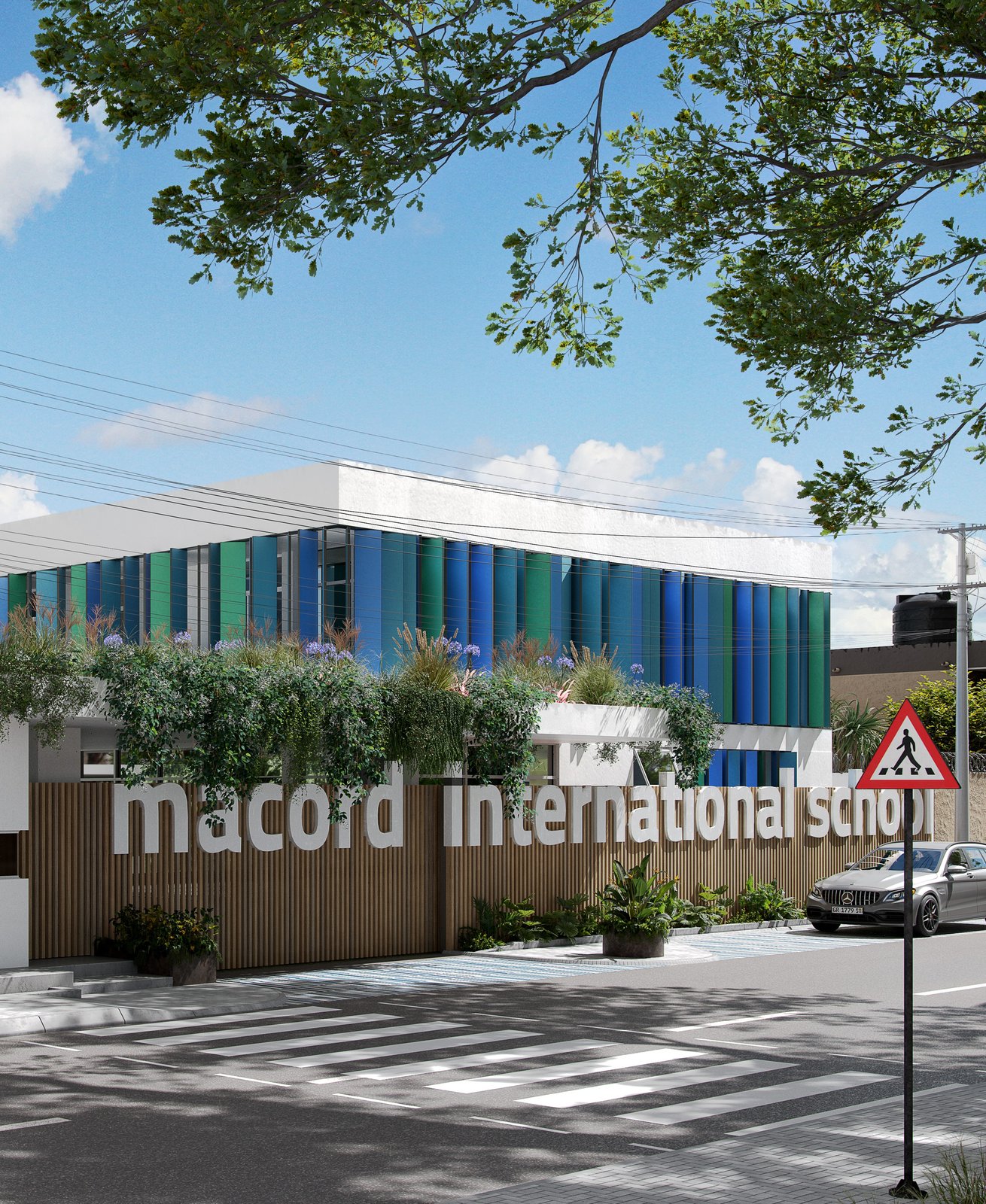 Macord International School at the corner: the same batten wall and lettering under a planted pergola, blue and green fins behind, a red triangular pedestrian-crossing sign at the right and zebra stripes across the foreground.