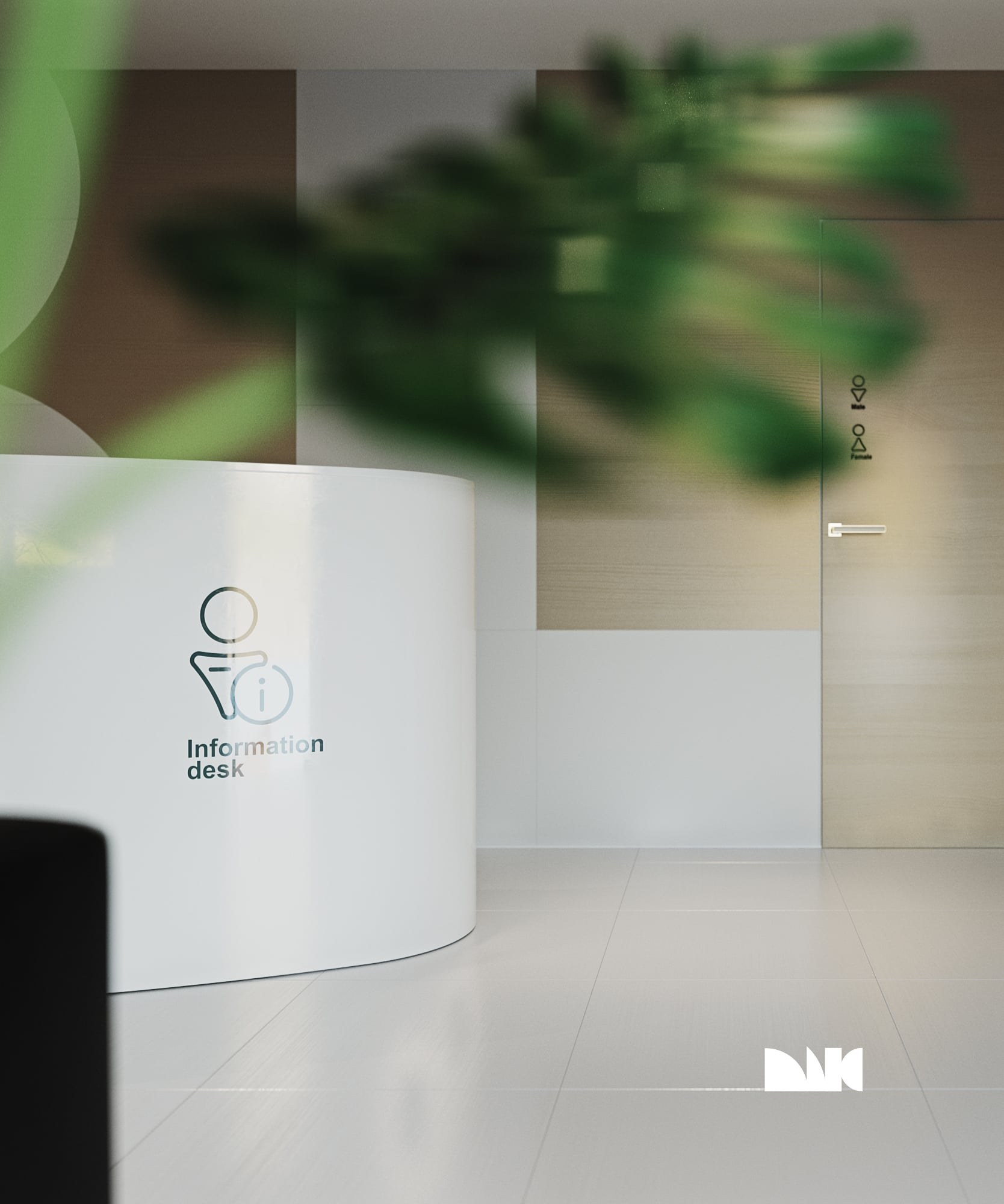 The white information desk installed in a lobby, seen past a plant.