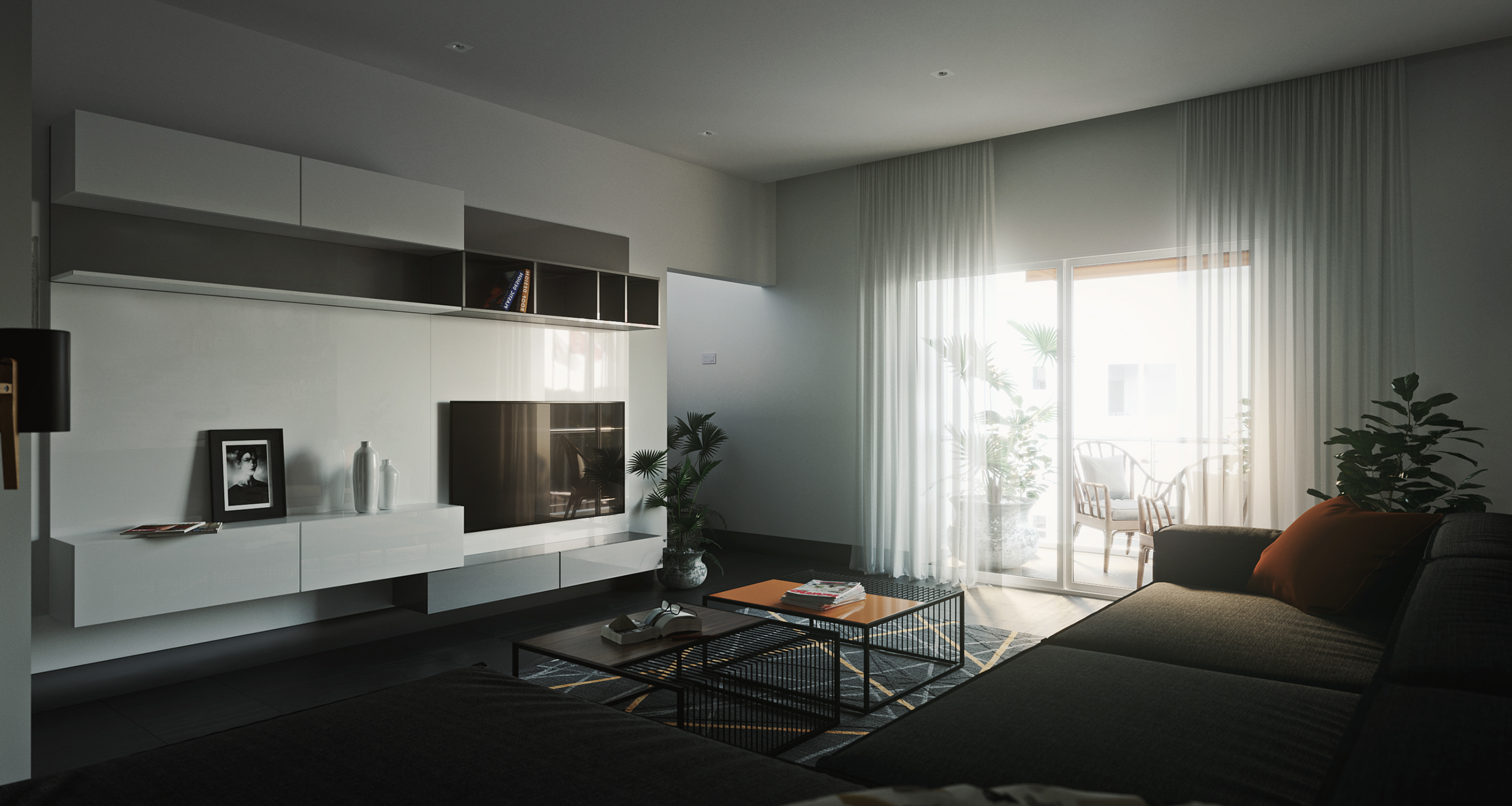 Naadei Villas living room: dark L-shaped sofa before nested wire coffee tables on a geometric grey rug, glossy white floating cabinets and a wall-mounted TV beside curtained balcony doors.