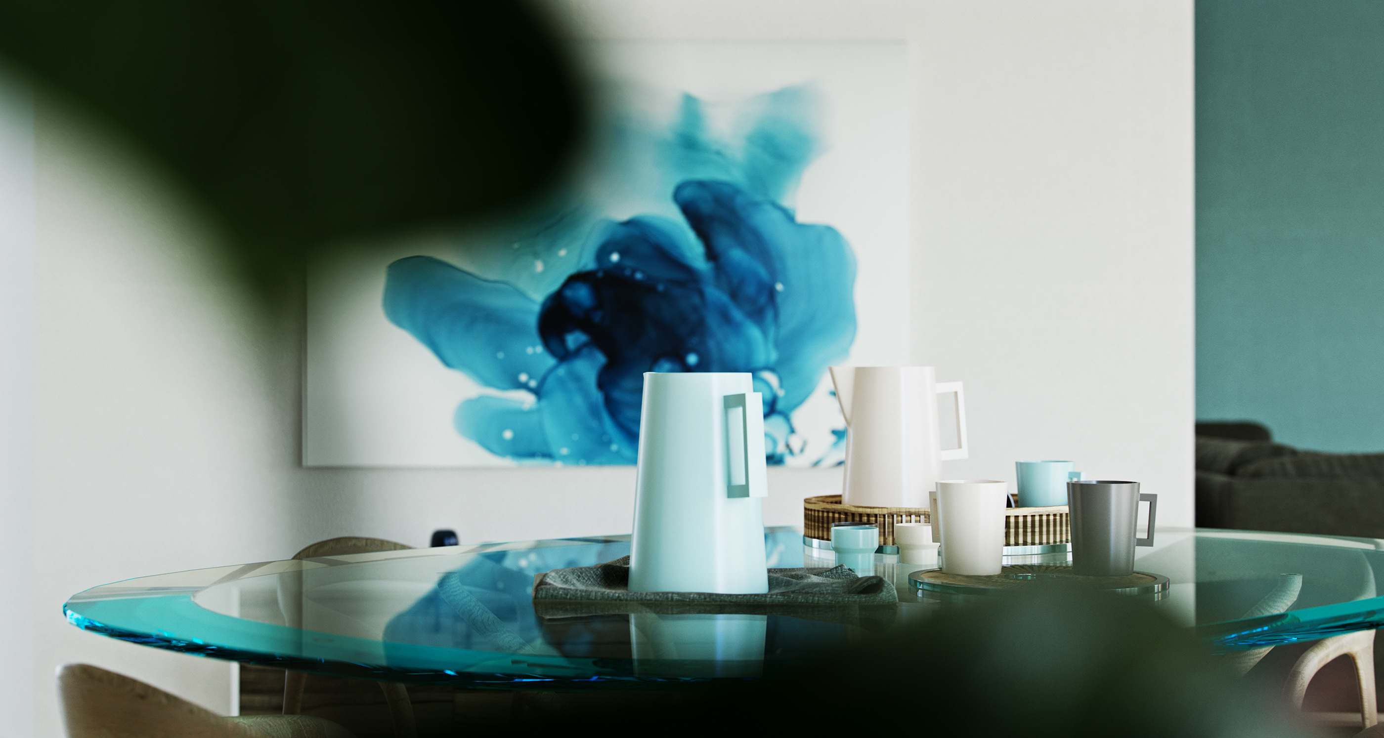Naadei Villas tabletop study: mint and cream jugs and cups arranged on trays across a glass-topped table, a blue ink-wash canvas out of focus behind.
