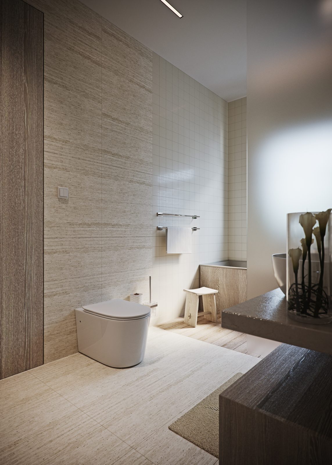 The wall-hung WC against the travertine wall, with a towel rail, a timber stool, the stone-clad built-in bath beyond and a stone counter carrying lilies in the foreground.