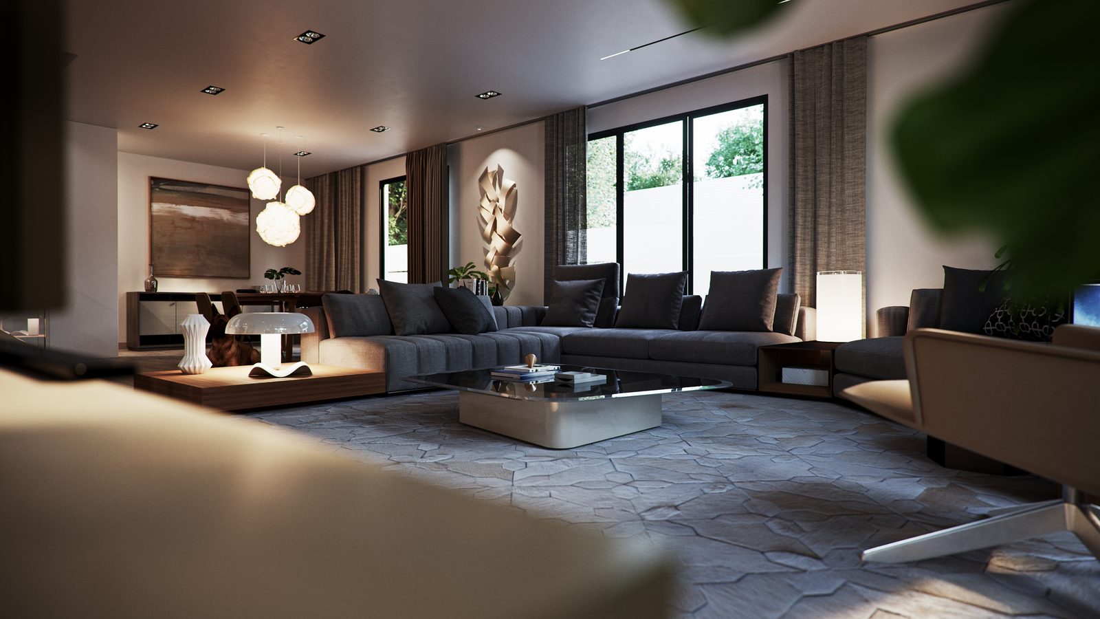 Evening view across the lounge to the window wall, ceiling track lights and a carved timber relief.