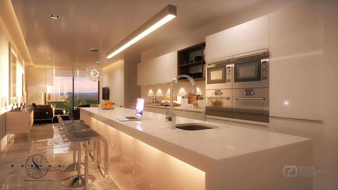 Kitchen close view along the island: a slim undermount sink and an open laptop sit on the white worktop, a linear pendant throws a hard band of light, and the stainless oven stack and pale floor reflections fill the background.