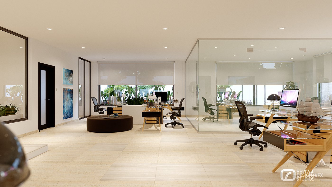 Wider open-plan render: a round ottoman in the middle of the floor, workstations with computers, a glass-walled meeting room with planting behind it and framed pictures on the left wall.
