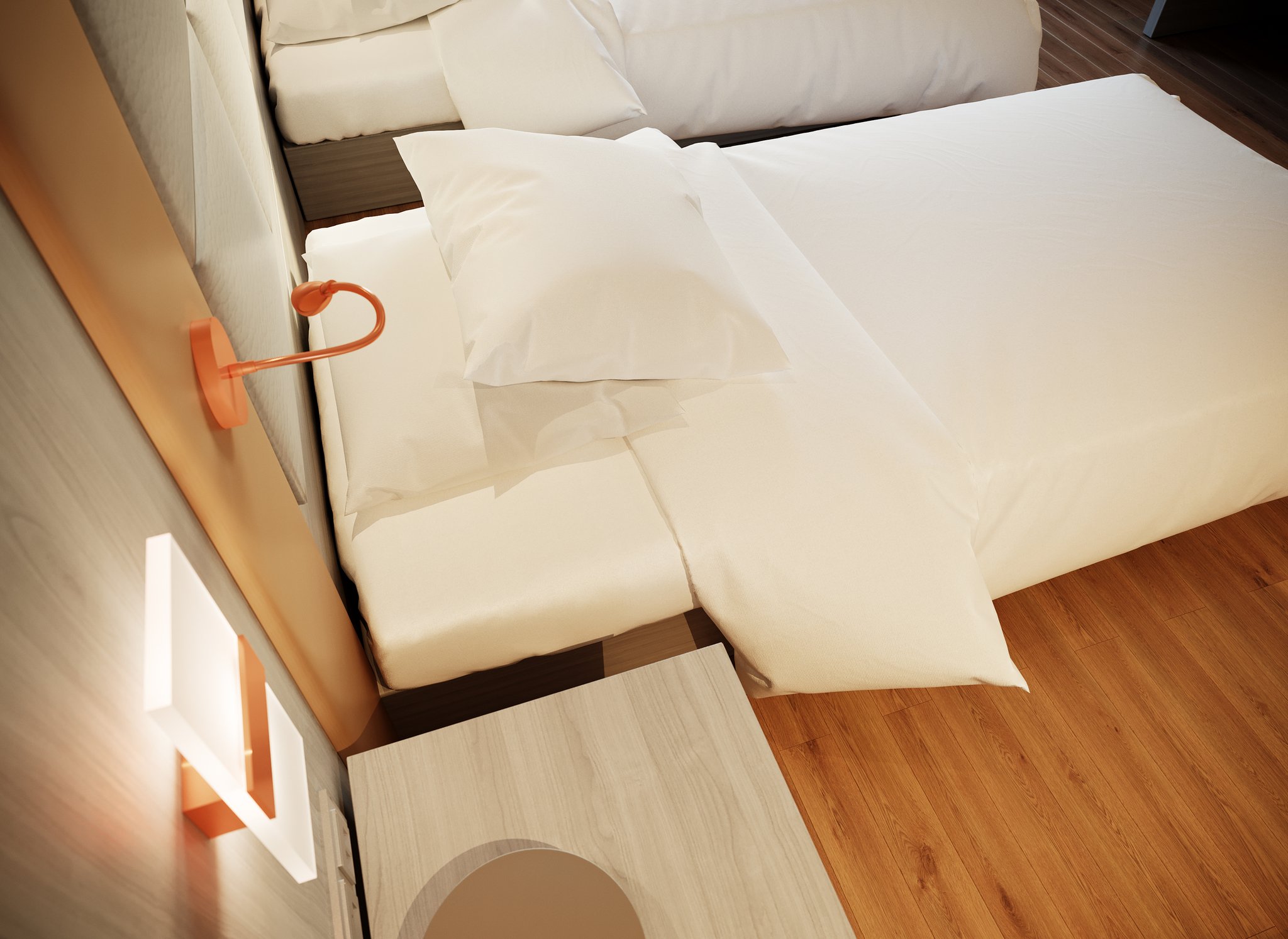 Protea Hotel Airport bedroom detail from above: the corner of a made bed with its pillow and turned-back duvet, a copper gooseneck reading lamp and a lit rectangular sconce on the padded headboard, and the edge of the nightstand on the oak floor.