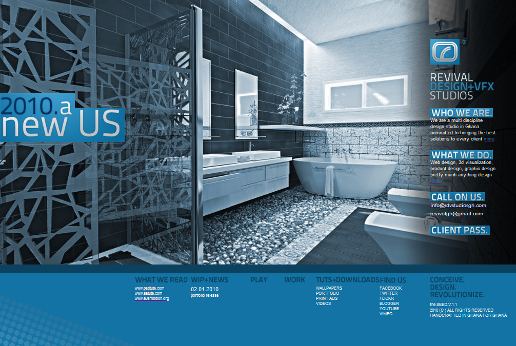 A full-width screenshot of the studio&rsquo;s own homepage, designed as one wide landscape frame. The left two thirds is a blue-grey 3D interior render of a bathroom -- dark tiled walls, a freestanding tub on a bed of pebbles, twin basins on a long counter, mirrors and a window -- overlaid at the left by a blue block carrying the words 2010. a new US in white. At the top right sits the studio&rsquo;s blue rounded-square mark with its registered symbol over the stacked wordmark REVIVAL DESIGN+VFX STUDIOS, and down the right side four blue heading blocks read WHO WE ARE., WHAT WE DO. and CALL ON US. and CLIENT PASS., each with white text under it: the multi-discipline studio statement, the list of web design, 3d visualization, product design and graphic design, and the two addresses info@rdvsstudiosgh.com and revivalgh@gmail.com. The whole composition sits on a solid blue footer band carrying the columns WHAT WE READ, WIP+NEWS, PLAY, WORK, TUTS+DOWNLOADS and FIND US -- the reading links www.psdtuts.com, www.aetuts.com and www.evermotion.org, a 02.01.2010 portfolio release item, the WALLPAPERS / PORTFOLIO / PRINT ADS / VIDEOS list and the six social routes -- with CONCEIVE. DESIGN. REVOLUTIONIZE., the SEED.V.1.1 and HANDCRAFTED IN GHANA FOR GHANA at the far right.