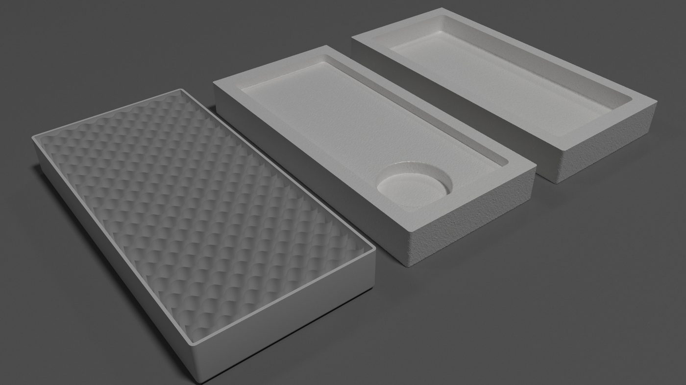 Primary package in clay: the moulded tray with a circular recess for the dial, its dimpled cushioning lid laid beside it.