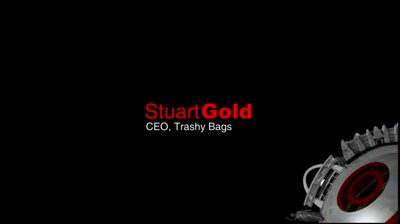 Video still, black frame: the speaker card Stuart Gold in red and white with CEO, Trashy Bags in small white text below, and a silver gear with red rings turning into the lower right corner.