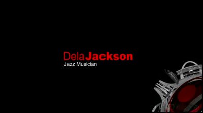 Video still, black frame: speaker card Dela Jackson in red and white, Jazz Musician in small white text beneath, and the silver-and-red gear element rising into the lower right corner of the shot.