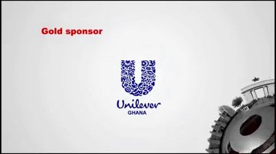 Video still on pale grey: Gold sponsor in red capitals over the blue mosaic Unilever U monogram with Unilever Ghana beneath it, and the same machined gear element entering at the lower right.