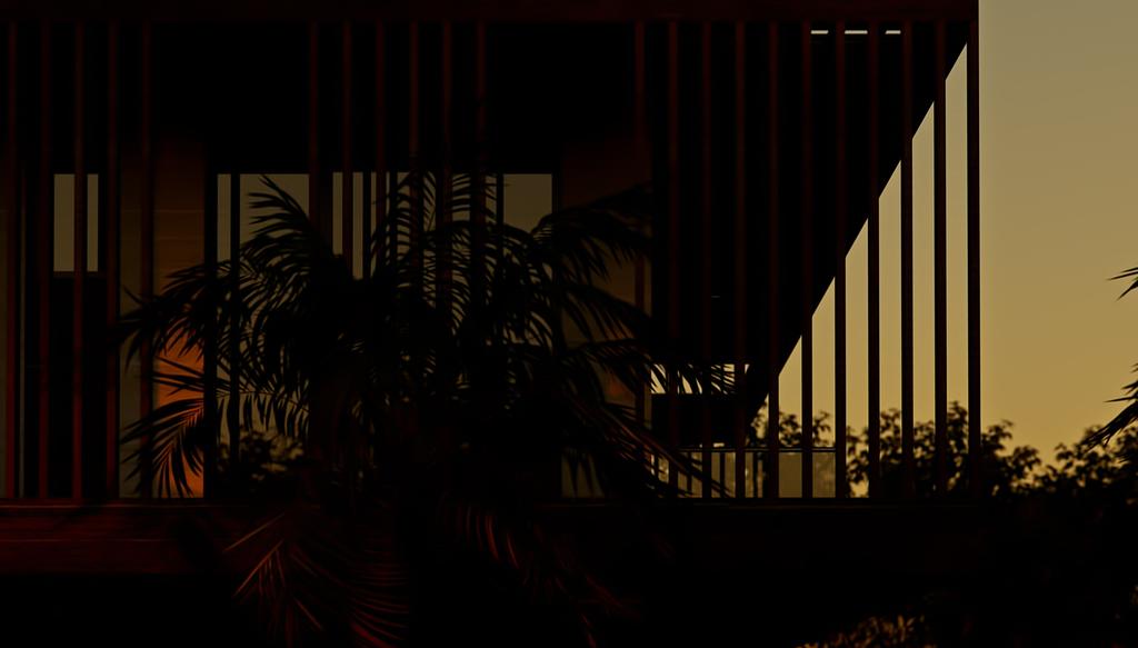 The Address at dusk: the vertical fins of the facade read as a dark screen against an amber sky, lit windows glowing orange behind them and a palm spreading across the lower left of the frame