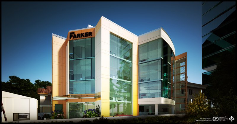 The main elevation at dusk: a mid-rise block of curved cream panels and tall glazed bays, its floors and green-tinted curtain wall reading from the inside and gathered on orange fins at the corners. A sign panel set high on the left bay carries the name the PARKER in black on orange. The sky is a deep clear blue, a low white service building sits at the left, and trees and shrubs frame the right and the planted foreground.