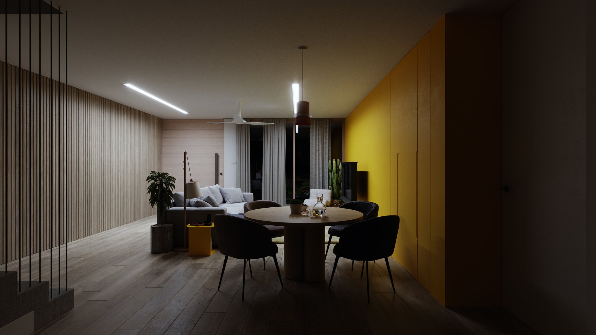 TTD open-plan dining and living at night: round oak table centred before a yellow cabinet wall, timber slats, LED strip, ceiling fan and curtained doors.