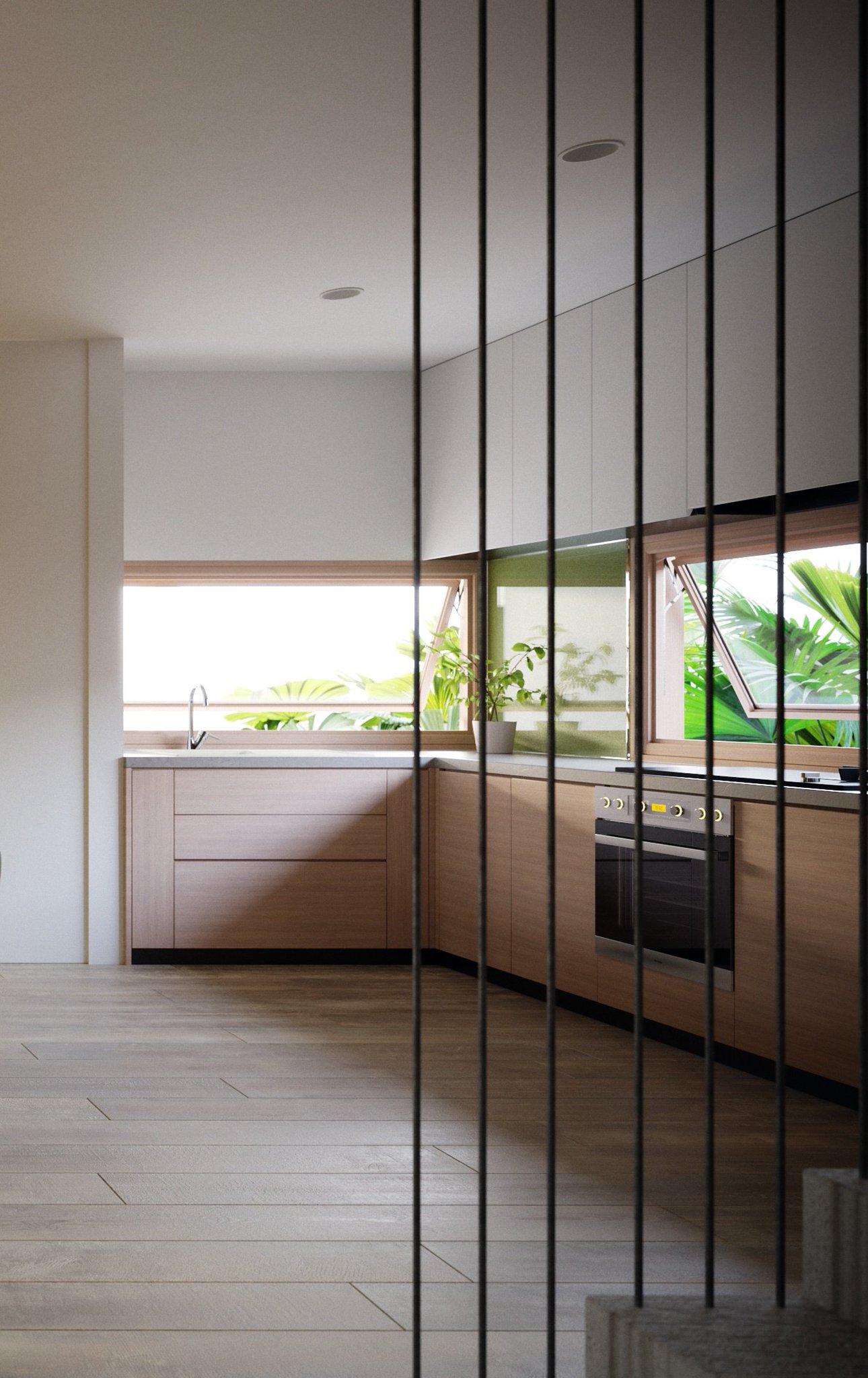 TTD kitchen seen through a black steel rod screen: pale wood base cabinets, white uppers, green glass splashback, awning windows and a steel oven.