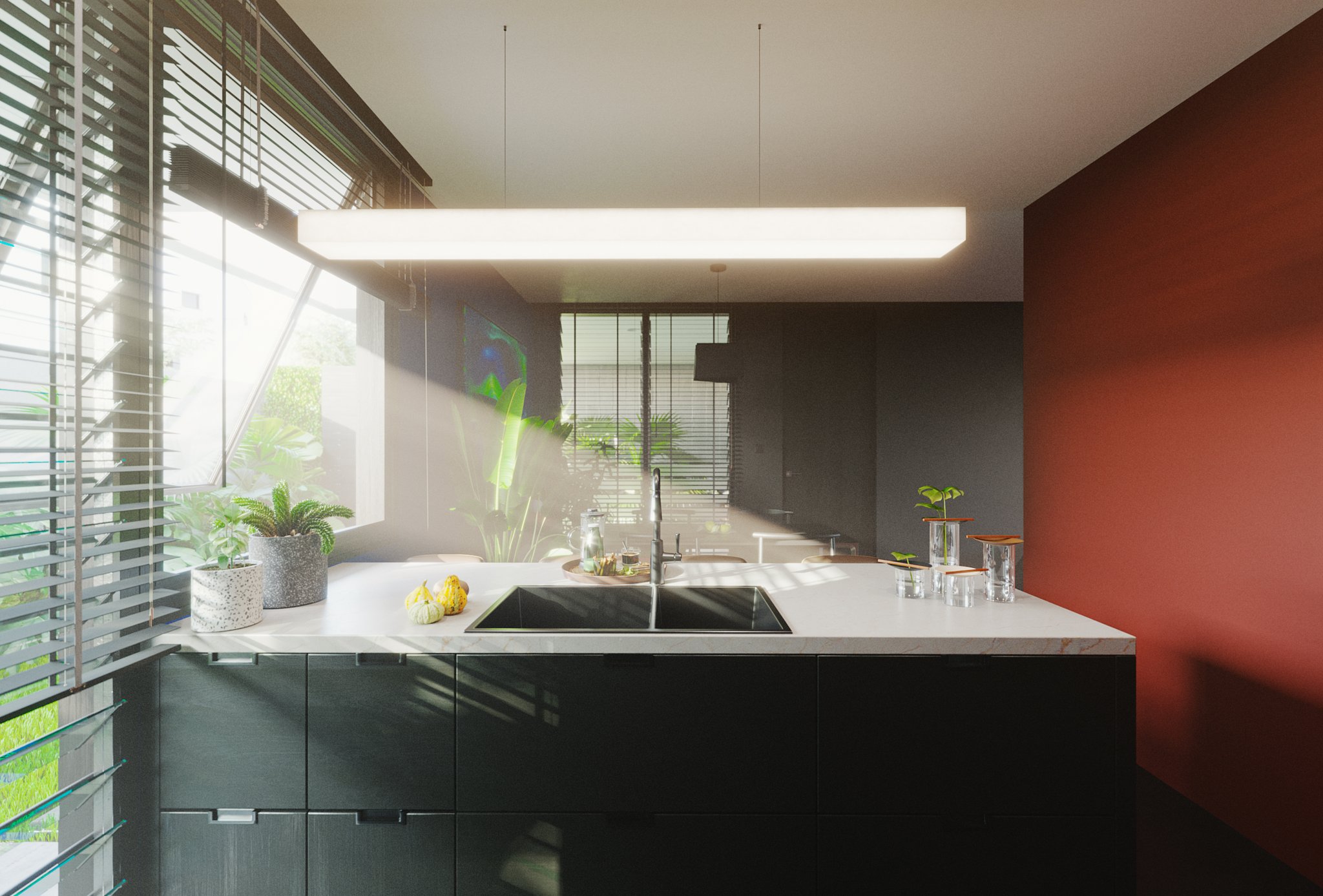TTD the same island framing in bright daylight: sun shafts through the blinds across the marble top, plants on the counter, red wall at the right.