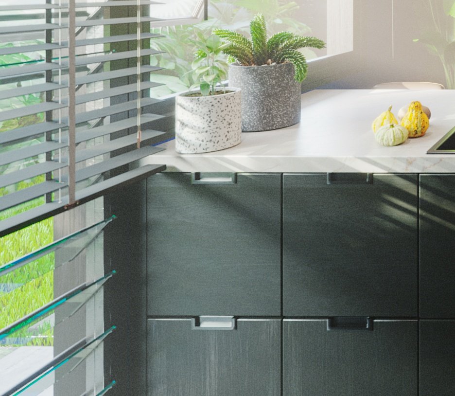 TTD close crop of the island end: dark cabinet fronts with recessed handles, two speckled plant pots and yellow gourds on the marble top.